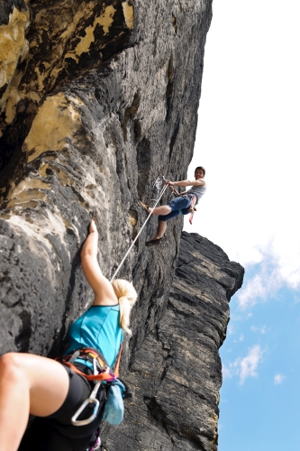 Rock Climbers Scaling Rock Wall